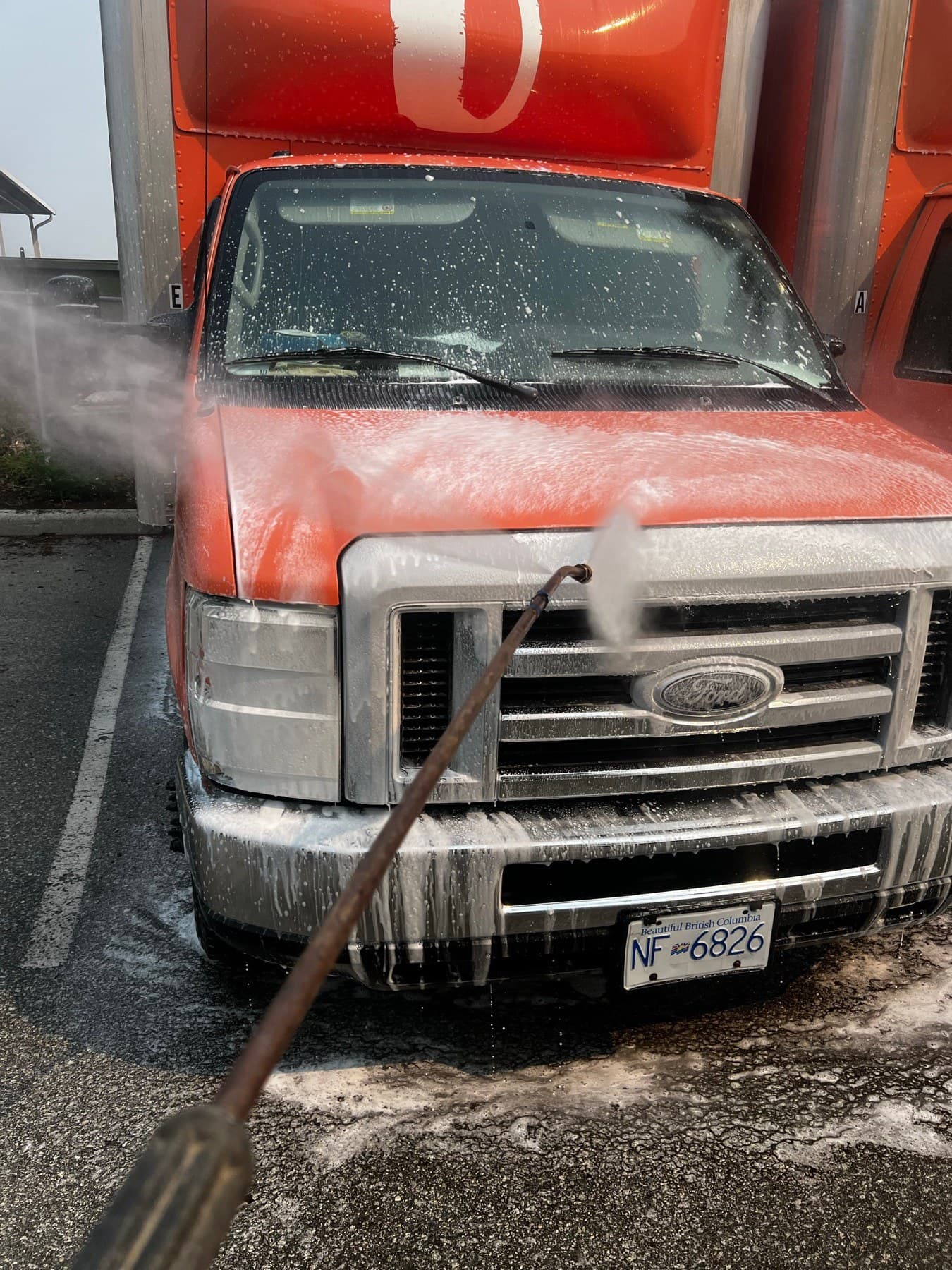 Fleet truck covered in foam mid-wash